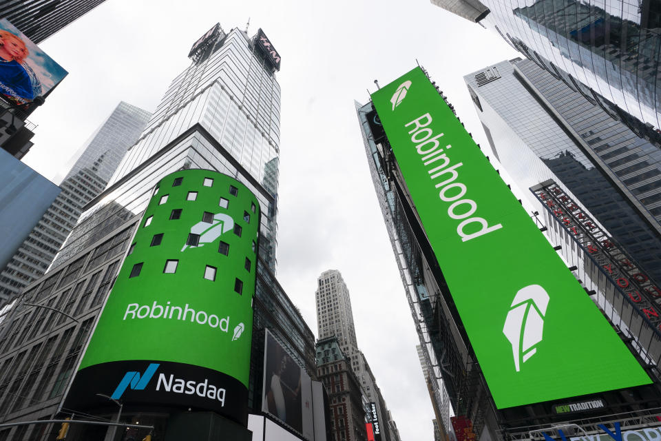 FILE - Electronic screens in Times Square in New York announce Robinhood's IPO, July 29, 2021. Robinhood Markets Inc. received a notice from the Securities and Exchange Commission regarding alleged securities violations in its crypto division .  The company said in a regulatory filing that it had received investigative subpoenas from the SEC on matters including cryptocurrency listings, cryptocurrency custody and platform operations.  (AP Photo/Mark Lennihan, file)