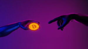 Hands imitating Michelangelo's pose from the Sistine Chapel, with one hand holding a Bitcoin (BTC) coin and the other reaching for it on a purple background