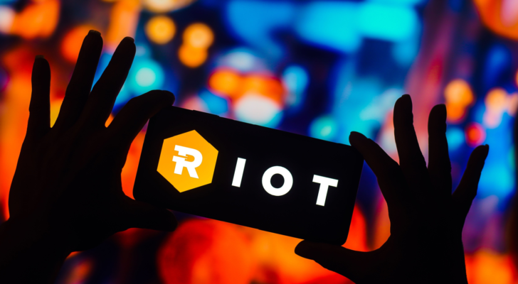 In this photo illustration, the Riot Platforms (RIOT) logo is displayed on the screen of a smartphone.