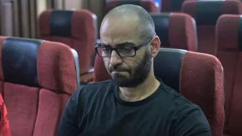 Getty Images Tigran Gambaryan, financial crime compliance manager at Binance Holdings Ltd., right, appears in court in Abuja, Nigeria, Thursday, April 4, 2024.