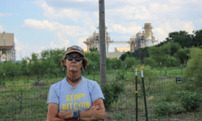 Cheryl Shadden stands outside her home in Granbury, Texas, with a view of Constellation Energy's Wolf Hollow II power plant in the background. Credit: Keaton Peters/Inside Climate News