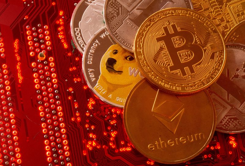 FILE PHOTO: FILE PHOTO: Representations of cryptocurrencies Bitcoin, Ethereum, DogeCoin, Ripple, Litecoin are placed on PC motherboard in this illustration taken